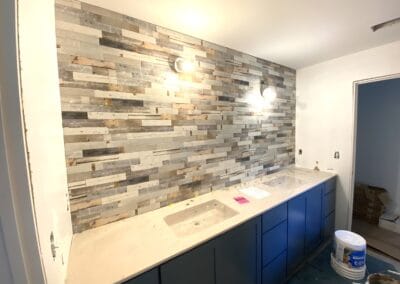 marble kitchen wall, kitchen sink with blue kitchen cabinets