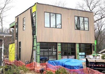 under construction custom modern home with wood sidings and large windows