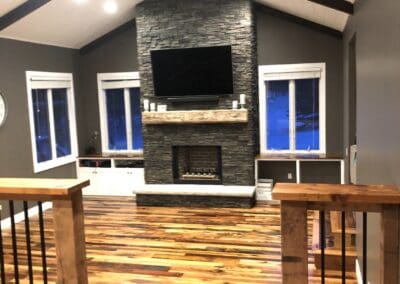 custom fire place with wood flooring and sliding windows