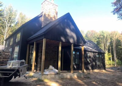 custom home dark blue roof dark gray paint brick chimney